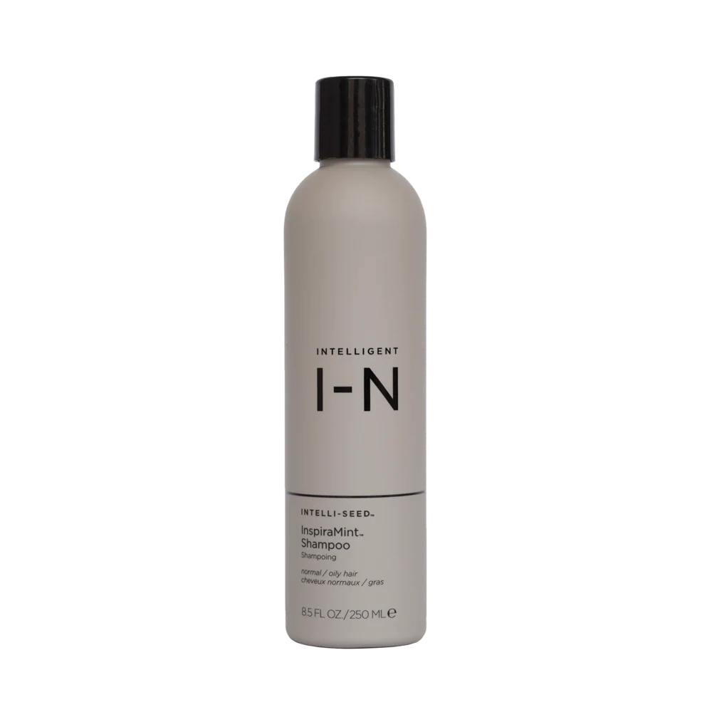 Shampoo bottle with black cap and label on a white background