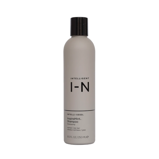 Shampoo bottle with black cap and label on a white background